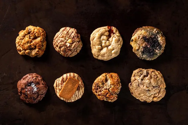 Fresh baked cookies and pastries styled on a dark surface