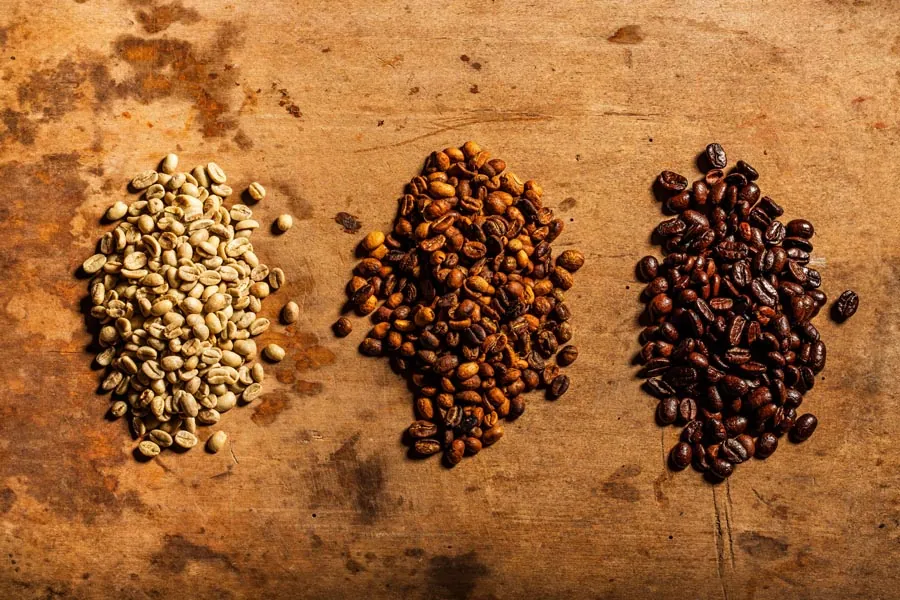 Roasted coffee beans and packaging styled with rich, warm light