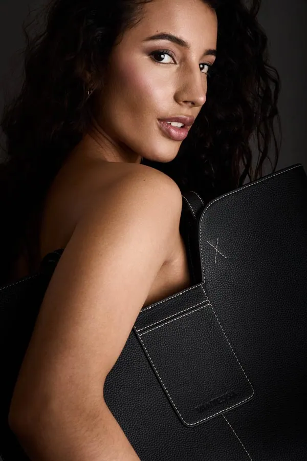 Studio portrait of a model against a dark backdrop